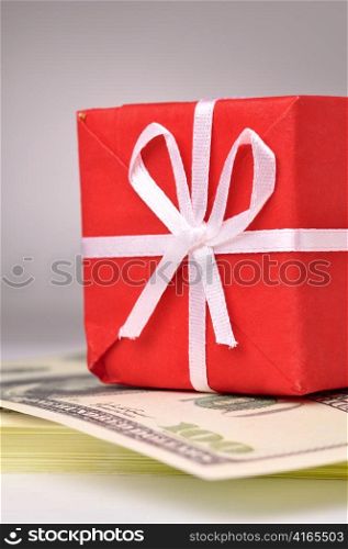 red gift box on the batch of dollars notes