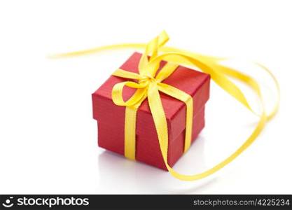 red gift box with a yellow ribbon isolated on white