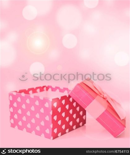 red gift box with hearts on bukeh background