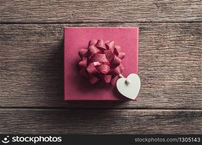 Red gift box with mini heart shape on old wooden background, Valentines day concept