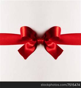 Red gift satin bow on white background. Red gift bow on white