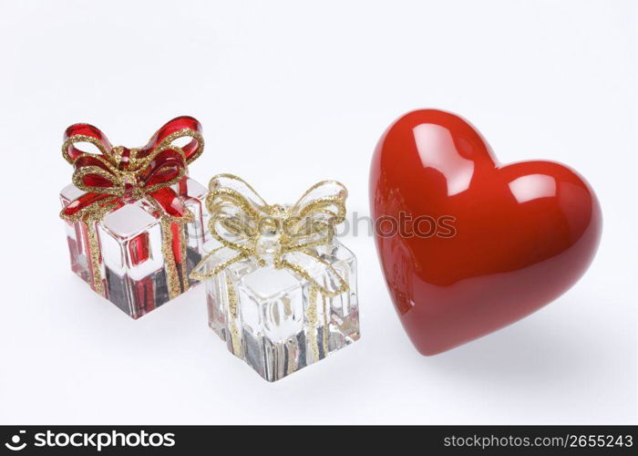 Red glass heart and glass presents isolated on a white background