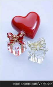 Red glass heart and glass presents isolated on a white background