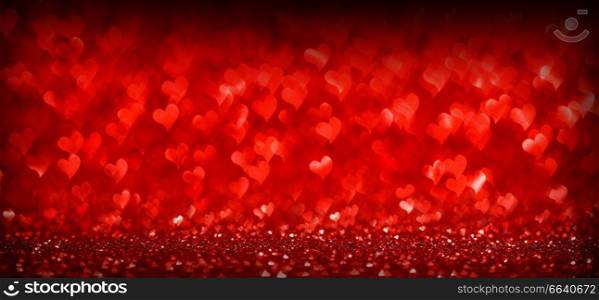 Red glowing bokeh hearts background for Valentines day. Red hearts background