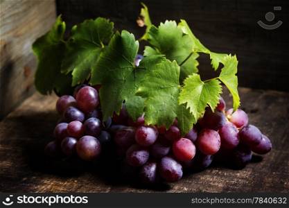Red grape on wooden background