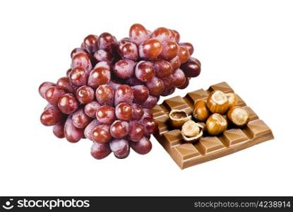Red grapes with chocolate and nuts in shells on white background