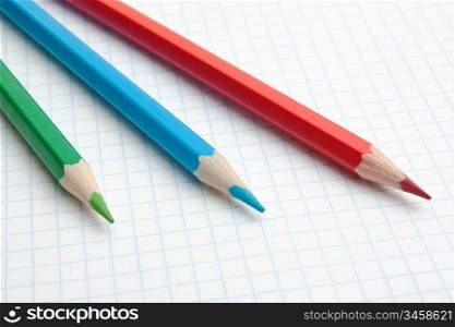 red, green, blue pencils and notebook