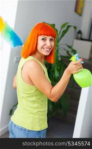 Red hair housewife cleaning her home with a spray