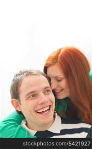 Red hair young woman whispering in boyfriends ear