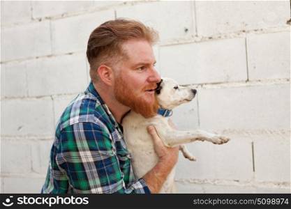 Red haired guy with his dog looking at the side