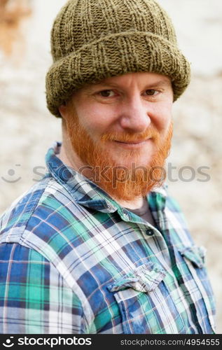 Red haired man with blue plaid shirt and wool hat