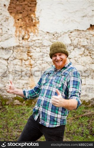 Red haired man with plaid shirt celebrating something