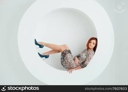 red-haired model girl with blue eyes on a white circle background