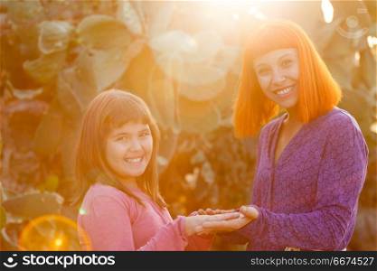 Red haired mom and her daughter. Beautiful family with a red haired mom and her daughter