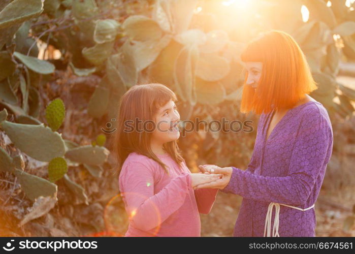 Red haired mom and her daughter. Beautiful family with a red haired mom and her daughter