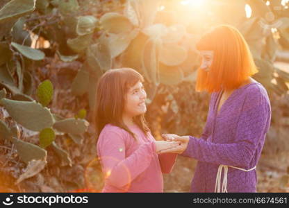 Red haired mom and her daughter. Beautiful family with a red haired mom and her daughter