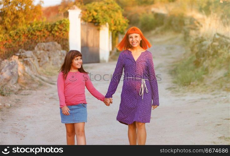 Red haired mom and her daughter. Beautiful family with a red haired mom and her daughter