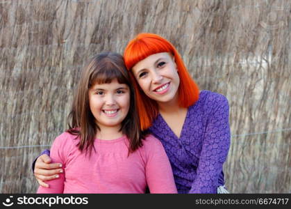 Red haired mom and her daughter. Beautiful family with a red haired mom and her daughter