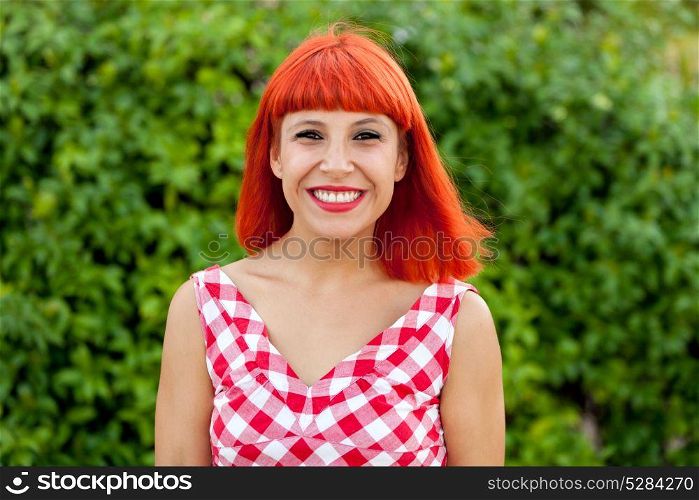 Red haired pretty woman relaxed in the park