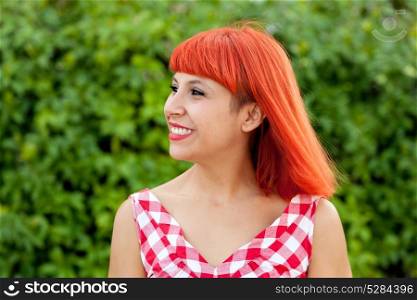 Red haired pretty woman relaxed in the park