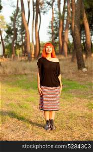 Red haired woman in the forest, enjoing of the a sunny day