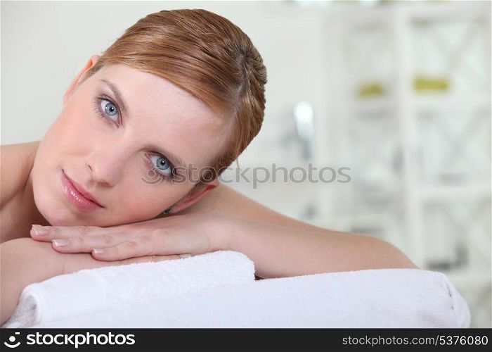Red-haired woman laying on couch