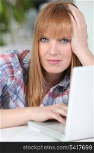 Red-haired woman on a laptop