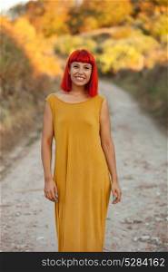 Red haired woman taking a walk by a path