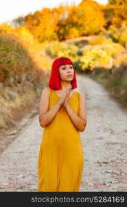 Red haired woman taking a walk by a path