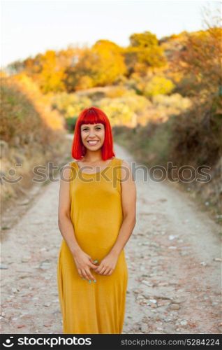 Red haired woman taking a walk by a path