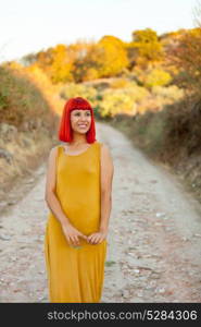 Red haired woman taking a walk by a path