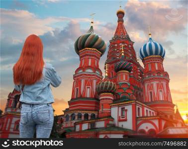 red-haired woman walks on Red Square in Moscow