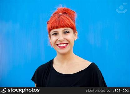 Red haired woman with black t-shirt on a blue background
