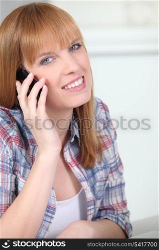Red-haired woman with mobile phone