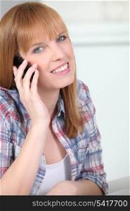 Red-haired woman with mobile phone