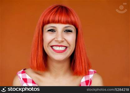 Red haired woman with red checkered dress on a orange background