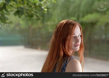 Red haired women looking back outdoor shot