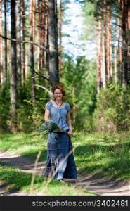 Red-haired women walking on path in the wood