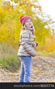 Red Hat girl on walk in autumn