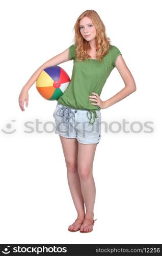 red head teen posing with a beach ball