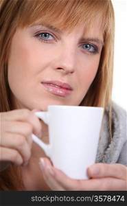 red head woman drinking a tea