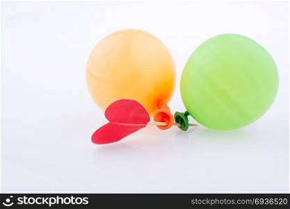 Red heart and colorful small balloons on a white background