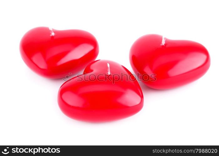 Red heart candles isolated on white background.