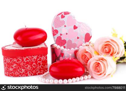 Red heart candles, roses, necklace and gift boxes on white background.