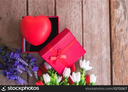 Red heart, flower and gift box on wooden background with copy space, valentine day concept