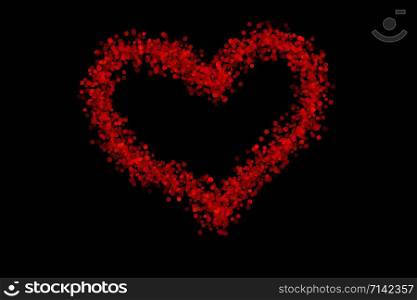 Red heart icon isolated on black background created from bokeh. Valentine&rsquo;s symbol