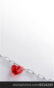 Red Heart laying in a metal chain in a corner of the staff. Chain of love
