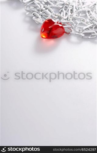 Red Heart laying in a metal chain in a corner of the staff. Chain of love with mark