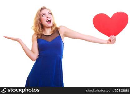 Red heart. Love symbol. Woman hold Valentine day symbol and showing empty hand palm with copyspace for product or text. Cute blonde girl in blue dress expressing tender feelings. Isolated studio shot