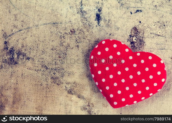 Red heart of polka dot fabric with copy-space on grunge background